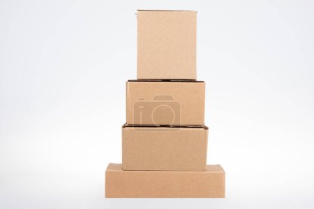 Photo for Stack of pyramid four cardboard boxes of different sizes on white background - Royalty Free Image