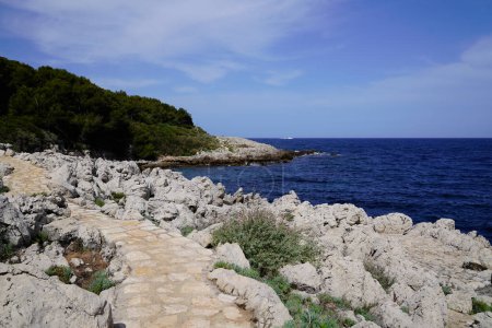 Photo for Beach stone pathway access sea coast in south Antibes Juan-les-Pins France southeast - Royalty Free Image