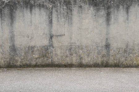 Aged gray cement wall with street and sidewalk grey background