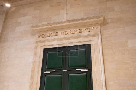 Foto de Police correctionnelle text on ancient wall facade building means in french justice Criminal Court courtroom - Imagen libre de derechos