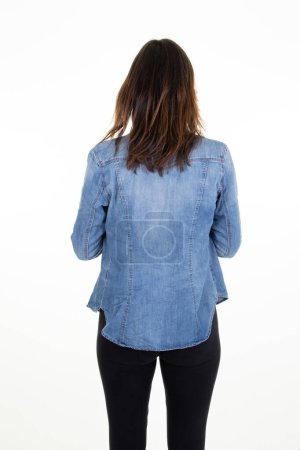 Foto de Rear view of unrecognizable young woman with long dark hair back isolated white background in studio shot lady back behind view - Imagen libre de derechos