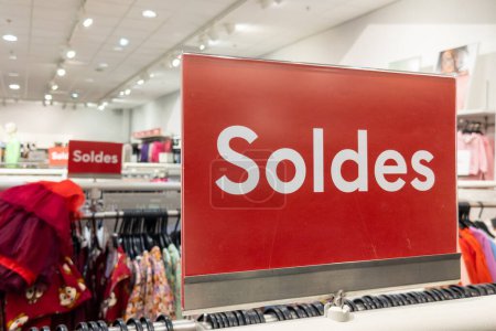 Photo for Soldes french text means red sale sign on shop shelf in clothing store - Royalty Free Image