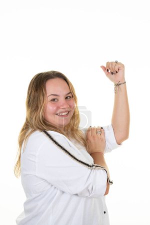 Téléchargez les photos : Curvy woman shows biceps overweight girl smiling happiness powerful flexing muscular arm in white background - en image libre de droit