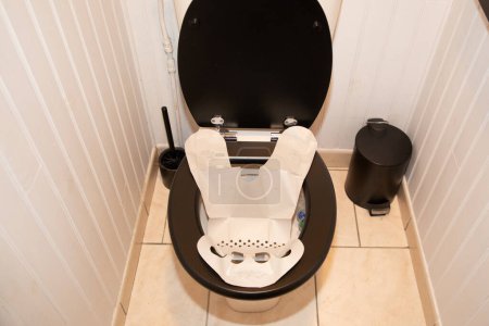 Photo for Stool collection facilitator device paper sleeve for the toilet seat used for tests which use stool as the sample source sitting on the toilet seat - Royalty Free Image