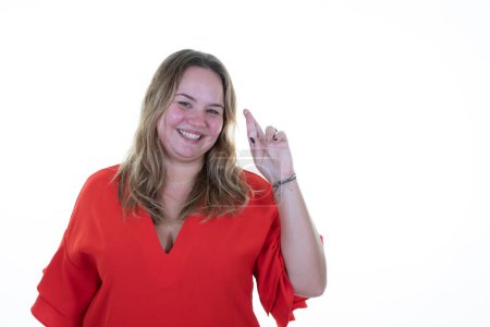 Téléchargez les photos : Overweight young woman looking happy and pointing up hand finger up copy space blank on white background - en image libre de droit