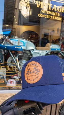 Photo for Bordeaux ,  Aquitaine France - 14 02 2023 : un barbu et une blonde logo brand and text sign on cap blue fashion clothes trendy vintage car motorbike in concept store - Royalty Free Image