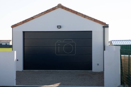 Photo for Facade large double garage sectional gray home door grey of residential house white - Royalty Free Image