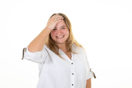 Téléchargez les photos : Blonde curvy jeune femme riant heureux avec doigt de main sur le front sur fond blanc - en image libre de droit
