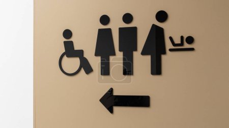 Photo for Wc Toilet sign on wall facade water closets with disabled man woman and baby - Royalty Free Image