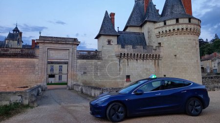 Photo for Tours , Aquitaine  France - 11 11 2023 : Tesla model 3 taxi sign logo and brand text on blue car front of french castle - Royalty Free Image