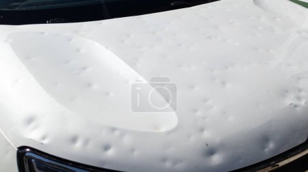 hailed car hood hail damage front car white damaged bonnet bodywork