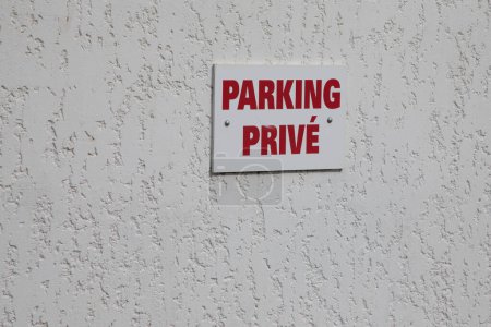 Photo for Parking prive french text sign red means private parking car parked in city street - Royalty Free Image