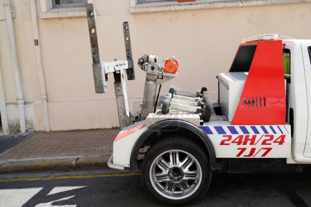 Photo for Bordeaux , France - 12 12 2023 : OMARS 2TZ Underlift Tow truck carrying improperly parked car or repossesed motorcycle and vehicle rescue and removal - Royalty Free Image