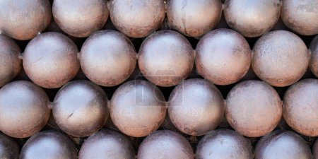 Photo for Cannon balls in stack pile of medieval weapon geometric background with plenty of cast steel iron spheres in row - Royalty Free Image