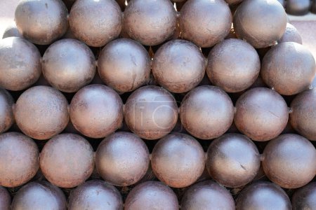 Photo for Cannon Balls round steel brown arranged in a pile background - Royalty Free Image