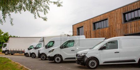 Photo for White truck van delivery group of unbranded white vans of different sizes ready for deliveries with your texts and logo in warehouse park - Royalty Free Image