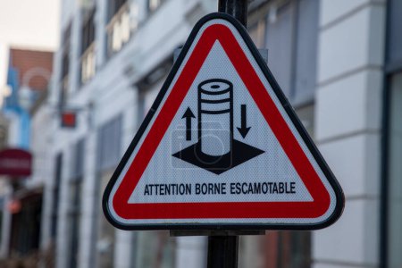 Photo for Attention borne escamotable french text sign means road sign indicating caution retractable bollard - Royalty Free Image