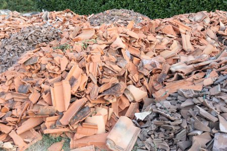 Photo for Old roof tile pile of broken roofing tiles on the street after a hailstorm for house restoration - Royalty Free Image