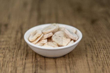 Photo for Freeze dried dehydrated banana slices can be ground up and added to a drink for a potassium boost. - Royalty Free Image