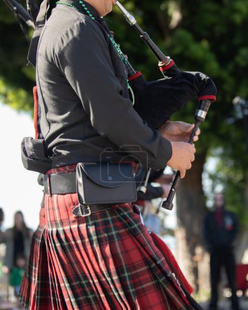 Bag pipe player wearing a kilt in honor of the Irish tradition during the St Patricks Day parade.