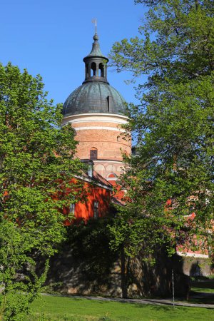 One tower of the 16th century Gripsholm castle imbedded in lush greenery.