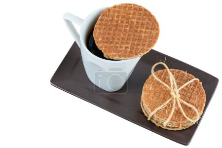 Photo for Stroopwafel cookies served with cup of coffee (top view)_white background. - Royalty Free Image