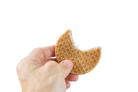 Photo for Man holding a stroopwafel cookie with a bite_white background. - Royalty Free Image