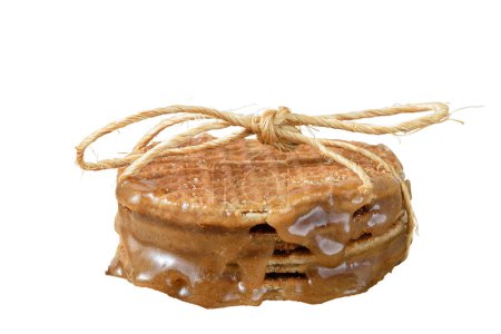 Photo for Several stacked stroopwafels, with a sisal bow and sugared syrup (side view)_white background. - Royalty Free Image