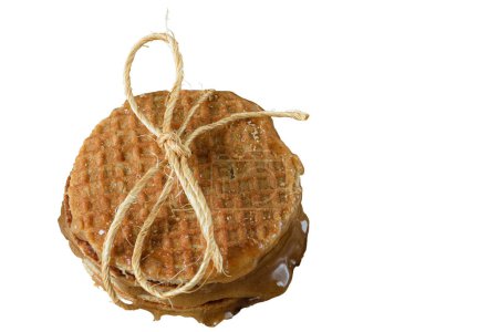 Photo for Several stacked stroopwafels, with a sisal bow and sugared syrup (top view)_white background. - Royalty Free Image