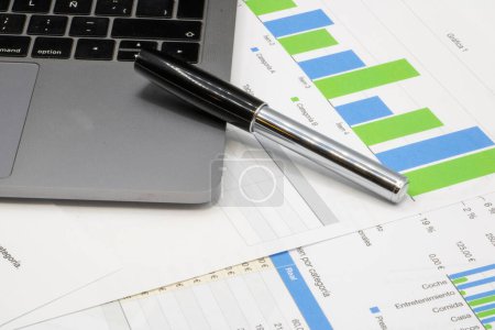 Photo for Note book over finance charts and a pen - Royalty Free Image