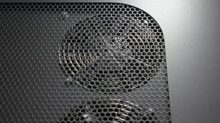 Foto de Close-up turned-off radiators of battery capacity tester. Black paneel with fan coolers. - Imagen libre de derechos