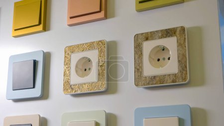 Photo for Various sockets and switches on the white wall. Electrical equipment store. - Royalty Free Image