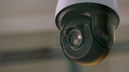Foto de Close-up of surveillance video camera rotating around. Security and safety. - Imagen libre de derechos