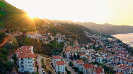 Photo for Sunrise over beautiful cityscape. City buildings, country road and mountains. Vacation at Turkey. - Royalty Free Image