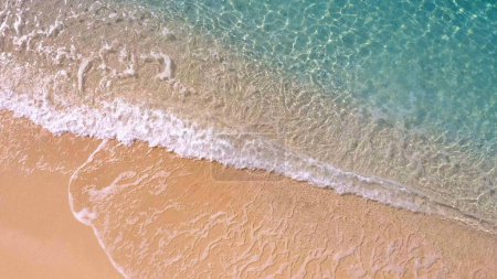 Photo for Sandy shore washing by clear turquoise waves. Aerial view from above. Summer paradise. - Royalty Free Image