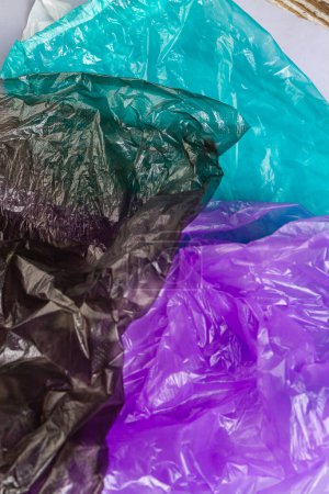 Foto de Primer plano de tres coloridas bolsas de plástico. Negro púrpura y turquesa. - Imagen libre de derechos