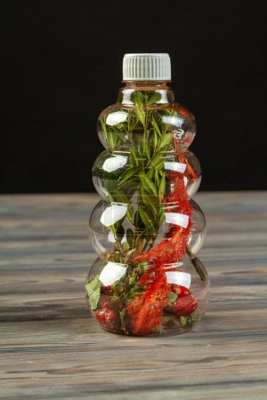 Photo for Close up relief plastic bottle of herbs. Concept of plasttic pollution. - Royalty Free Image
