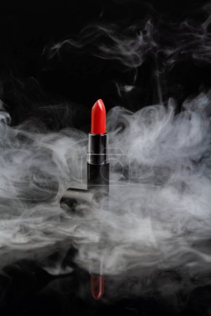 Téléchargez les photos : Red lipstick with steam on black background. Vertical shot close up. - en image libre de droit