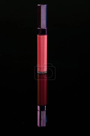 Photo for Vertical shot close up of red lip gloss. Isolated on black. - Royalty Free Image