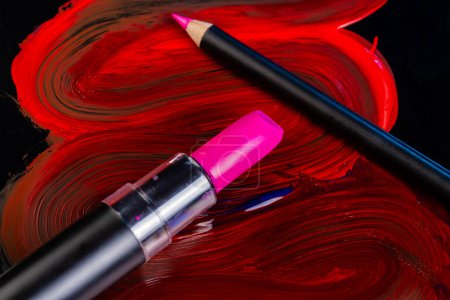 Photo for Close up of pink lipstick and pencil. Red smudged strokes. - Royalty Free Image