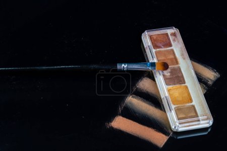 Photo for Make up palette and brush on black background. Cosmetic beauty tool. - Royalty Free Image