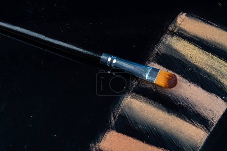 Photo for Makeup brush with powder samples on black background. Cosmetic products for beauty. - Royalty Free Image