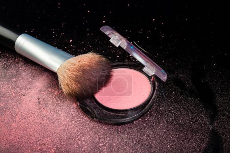 Photo for Close up of a make up brush and round cosmetic powder box. Cosmetic accessories on black background. - Royalty Free Image
