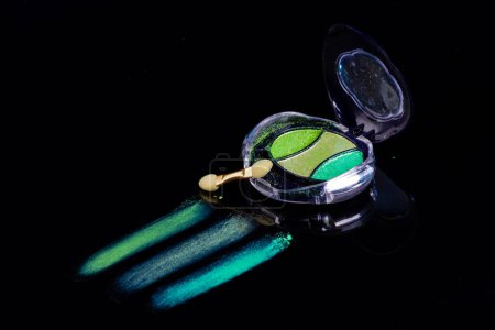 Téléchargez les photos : Colorful eye shadow palette and double end brush. Color makeup with green shimmer shadows. - en image libre de droit