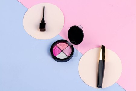 Photo for Top view make up accessories on pink and blue background. Eyeshadow palette and sticks. - Royalty Free Image