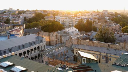 Téléchargez les photos : Aerial drone view of Odessa city at sunset or sunrise. Urban scape with buildings roofs. - en image libre de droit