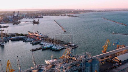 Photo for Industrial port. Ships, elevators and cranes in the sea bay. - Royalty Free Image