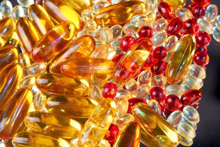 Photo for Close up pile of golden capsules of vitamin D3. Biologically active substances. - Royalty Free Image
