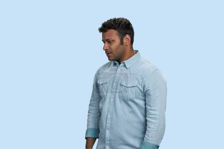 Photo for Young upset indian man on blue background. Unhappy depressive man. - Royalty Free Image
