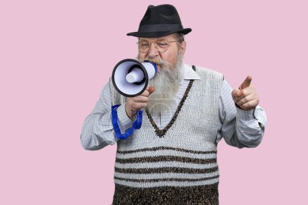 Photo for Expressive aged man giving a speech in megaphone. Isolated on pink background. - Royalty Free Image